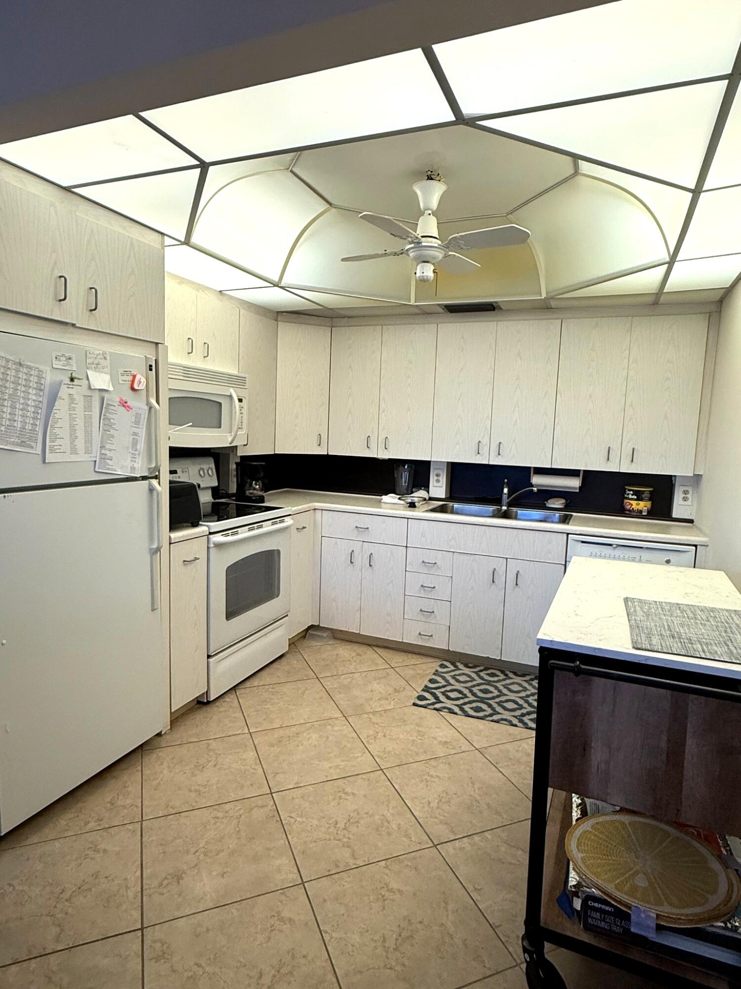 4032 Yarmouth C Boca Raton, FL 33434 - Photo 4 of 14 a kitchen with stainless steel appliances granite countertop a sink and cabinets