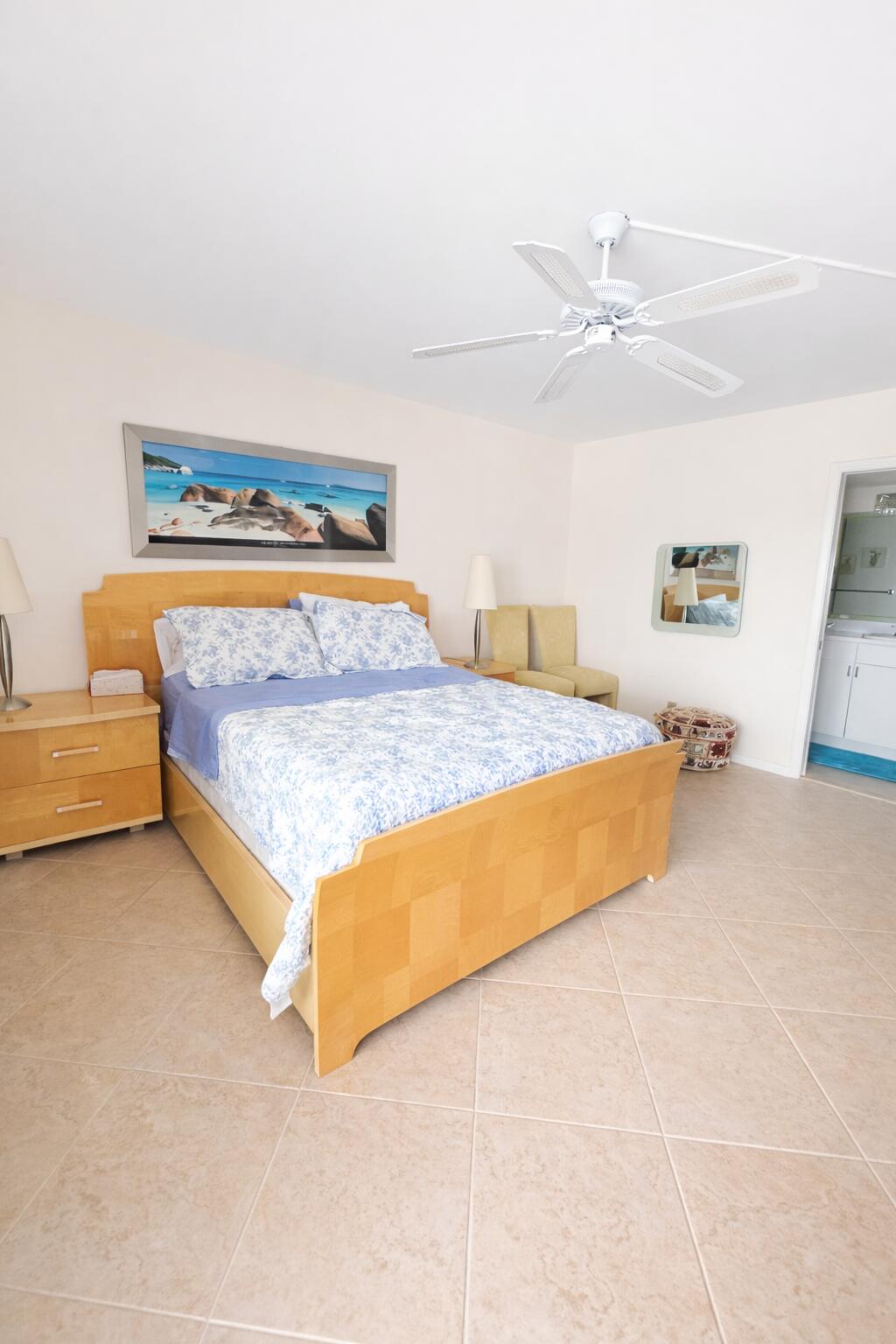 4032 Yarmouth C Boca Raton, FL 33434 - Photo 7 of 14 a bedroom with a bed and ceiling fan