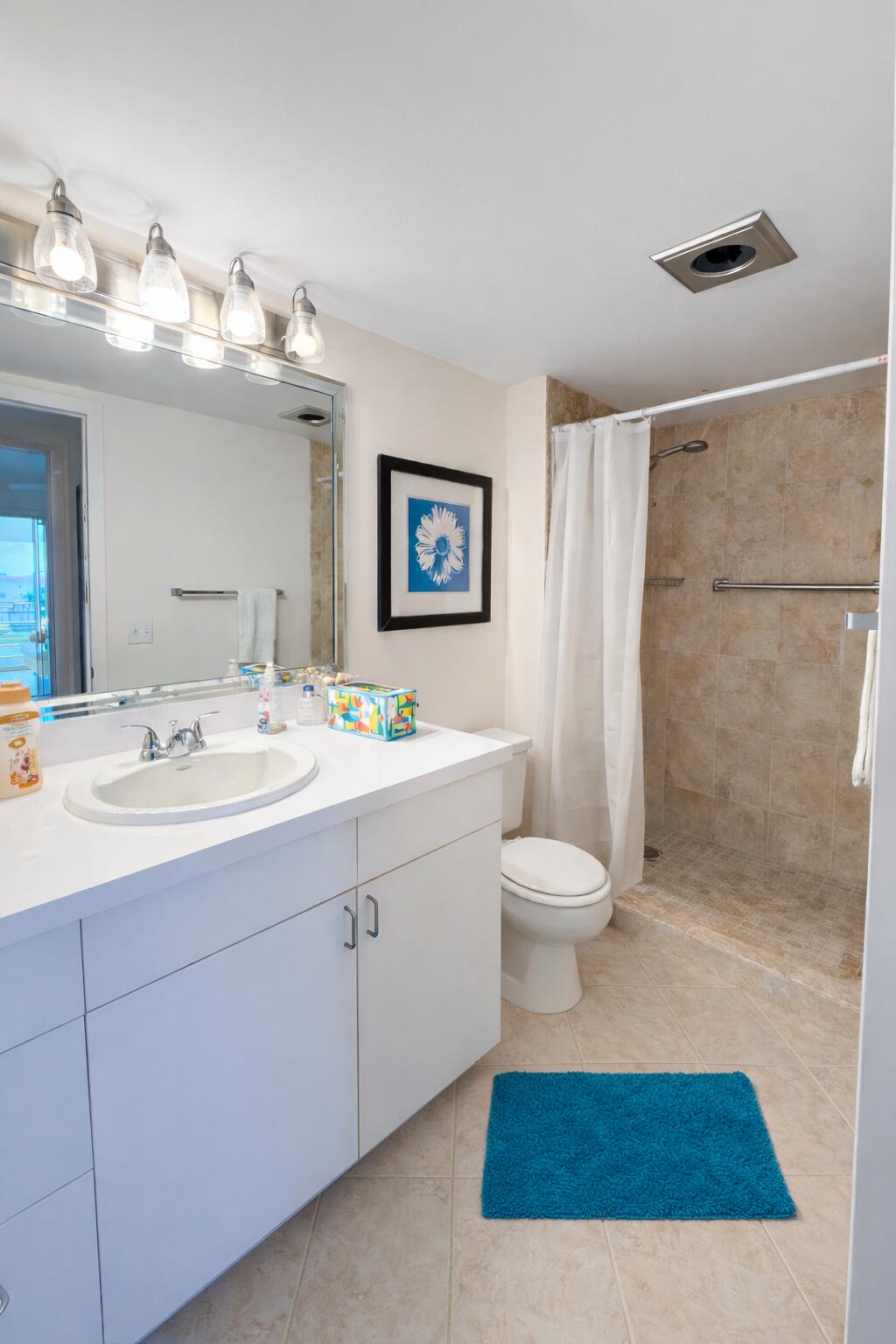 4032 Yarmouth C Boca Raton, FL 33434 - Photo 10 of 14 a bathroom with a toilet a sink and a mirror