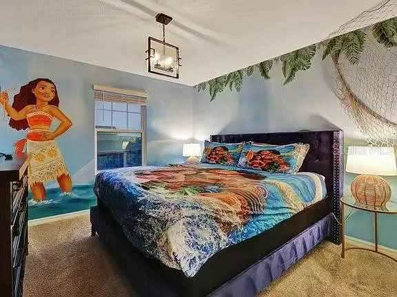 a living room with a bed and a chandelier