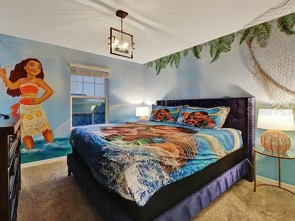 1919 Tropical Palms Circle Kissimmee, FL 34747 - Photo 13 of 41 a bed sitting in a bedroom next to a window