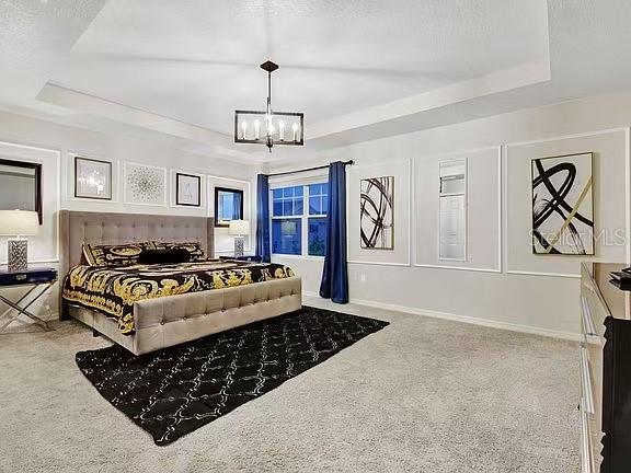 1919 Tropical Palms Circle Kissimmee, FL 34747 - Photo 15 of 41 a living room with a bed and a chandelier