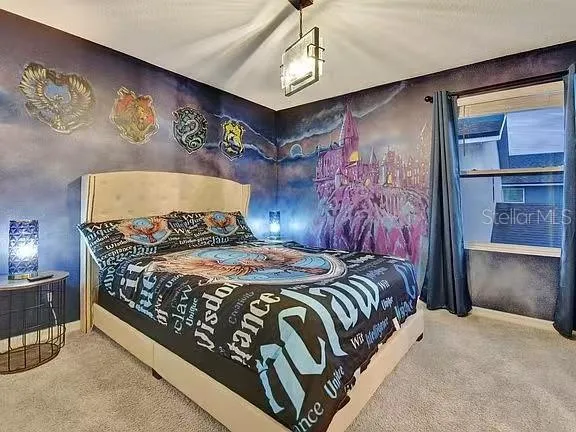 a bedroom with a bed and dresser with mirror