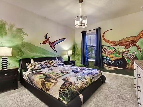 1919 Tropical Palms Circle Kissimmee, FL 34747 - Photo 21 of 41 a bedroom with a bed and dresser with mirror