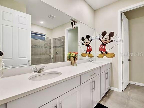 1919 Tropical Palms Circle Kissimmee, FL 34747 - Photo 30 of 41 a bathroom with a sink double vanity and a mirror