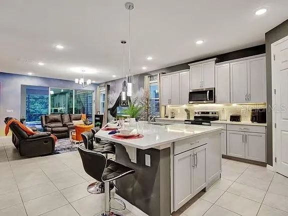 a living room with furniture and a chandelier