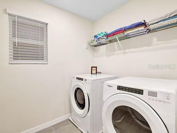 1919 Tropical Palms Circle Kissimmee, FL 34747 - Photo 31 of 41 a utility room with dryer and washer