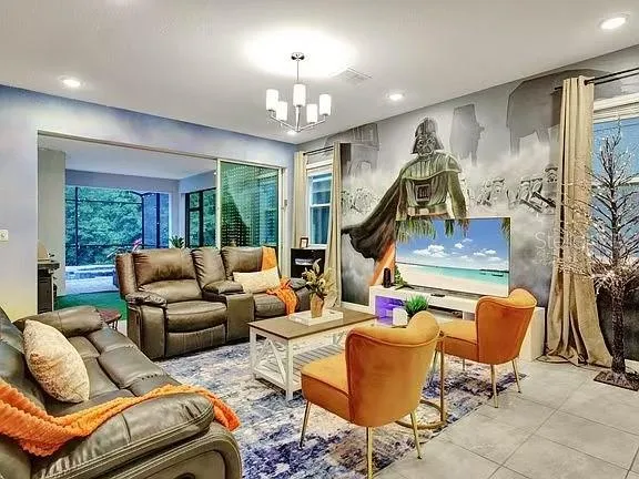 a living room with furniture and kitchen view