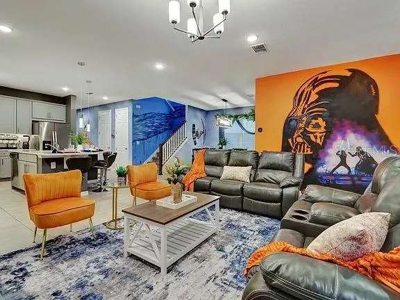 a kitchen with stainless steel appliances kitchen island granite countertop a sink a stove and a refrigerator