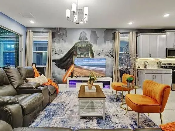 a living room with furniture and a floor to ceiling window