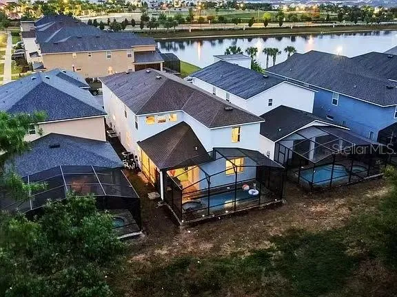 a spacious bedroom with a large bed and a chandelier