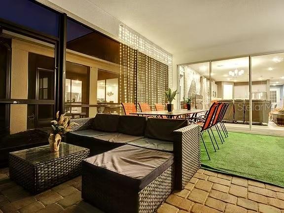 1919 Tropical Palms Circle Kissimmee, FL 34747 - Photo 10 of 41 a living room with furniture and a floor to ceiling window