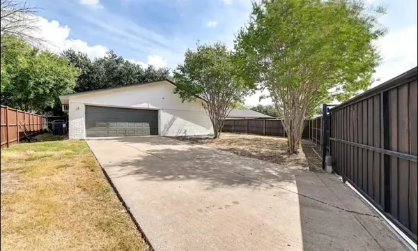 a white house covered with snow in front of house