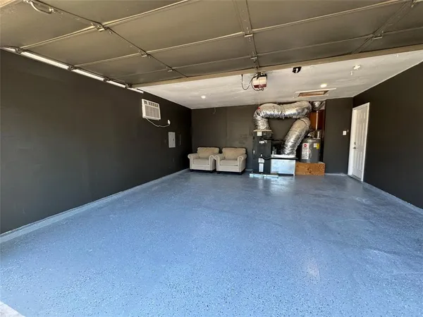 a view of a backyard with wooden fence and large trees