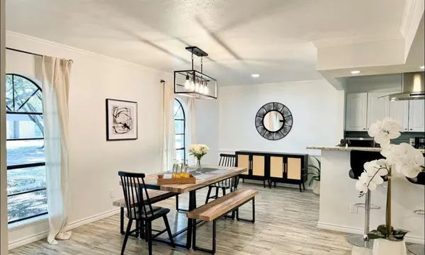 a kitchen with granite countertop a stove and a wooden floors