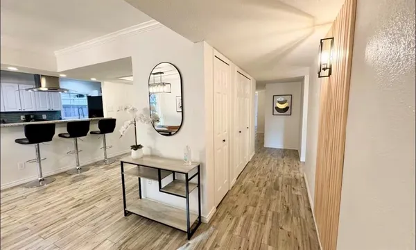 a view of a dining room with furniture and a chandelier