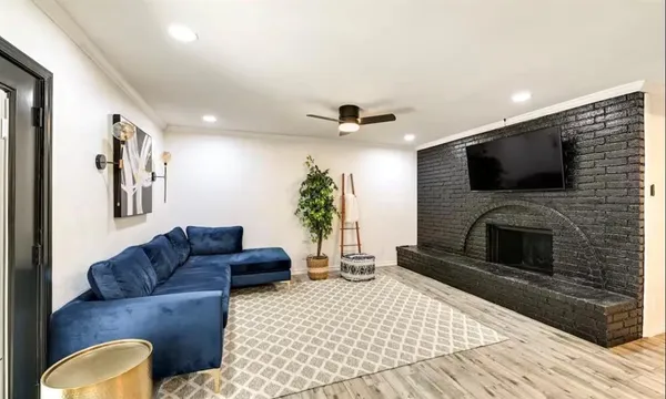 a view of living room with furniture and wooden floor