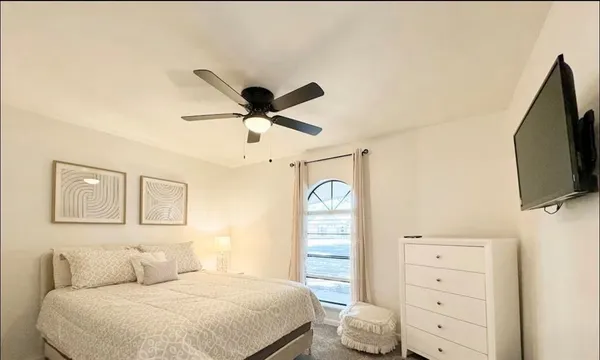 a bedroom with a bed and a flat screen tv