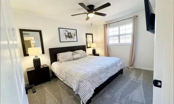 a bedroom with a bed and a flat screen tv