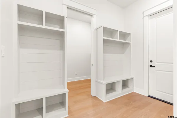 a view of storage and utility room with wooden floor