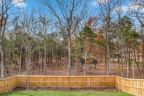 a view of a patio with table and chairs with wooden floor and fence