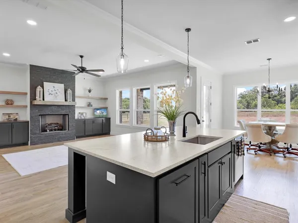 a kitchen with sink refrigerator and stove