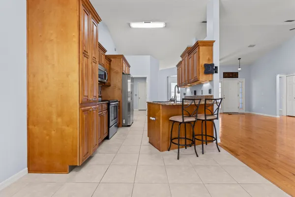 a view of a kitchen with furniture and an entryway