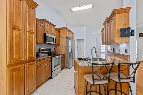 a kitchen with stainless steel appliances granite countertop a sink and cabinets