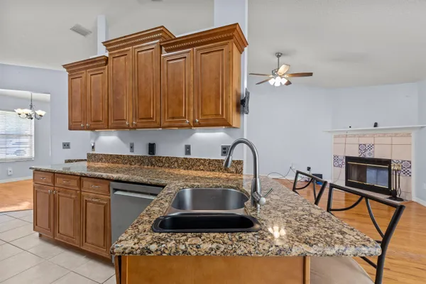 a kitchen with a stove a sink and a cabinets