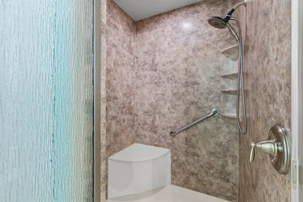a bathroom with a toilet and a shower