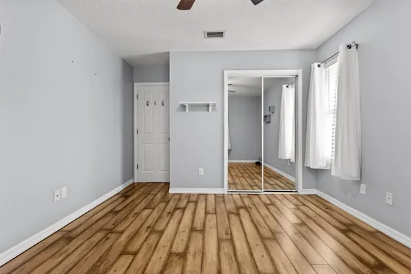 a view of a room with wooden floor and door