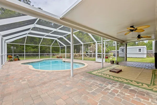 a view of a swimming pool with a lounge chair