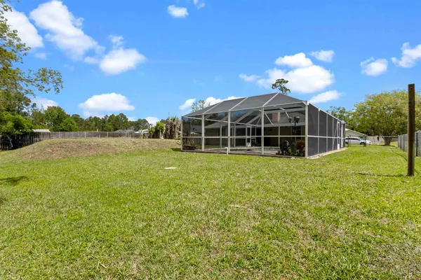 a view of a house with a backyard