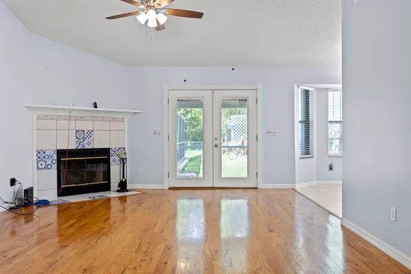 a view of an empty room with window and fire place