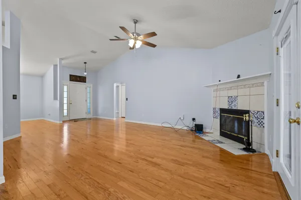 a view of empty room with fireplace and fan