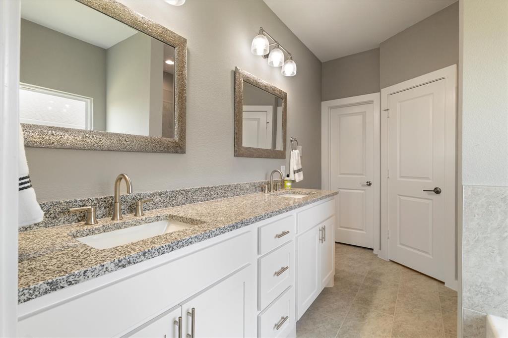 434 Cirrus Circle Muenster, TX 76252 - Photo 16 of 29 a bathroom with a granite countertop sink double and mirror