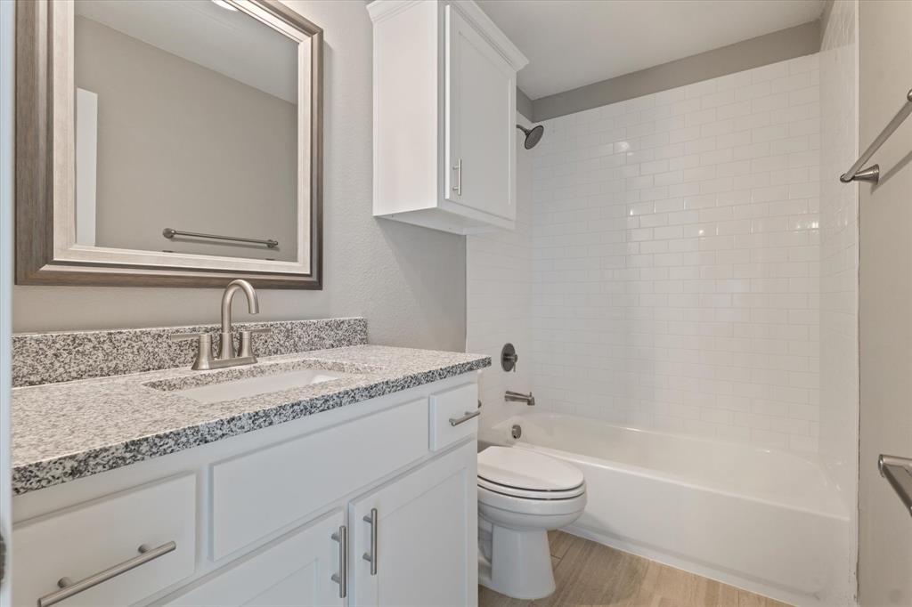 434 Cirrus Circle Muenster, TX 76252 - Photo 22 of 29 a bathroom with a granite countertop sink a toilet and bathtub