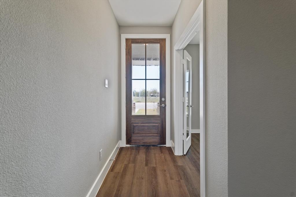 434 Cirrus Circle Muenster, TX 76252 - Photo 9 of 29 a view of an empty room with wooden floor and a window