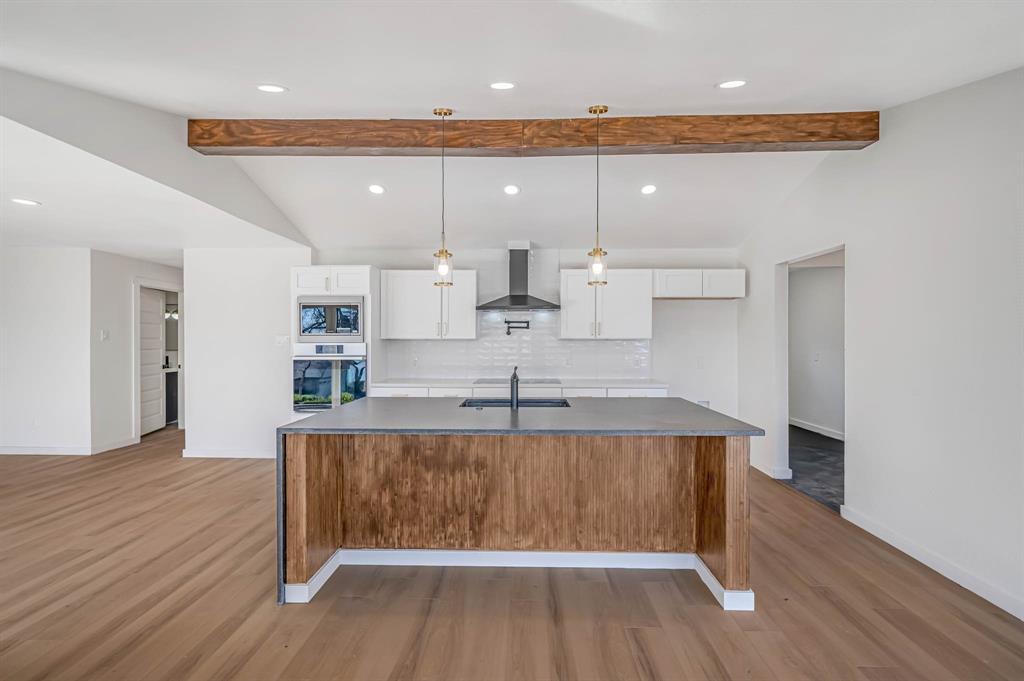 109 Pecan Drive Rowlett, TX 75087 - Photo 14 of 39 a large kitchen with a table and chairs