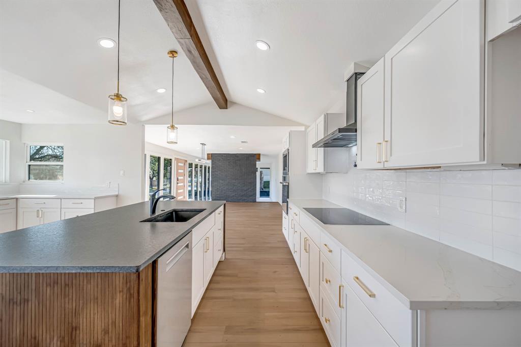 109 Pecan Drive Rowlett, TX 75087 - Photo 16 of 39 a kitchen with granite countertop a sink and a stove top oven