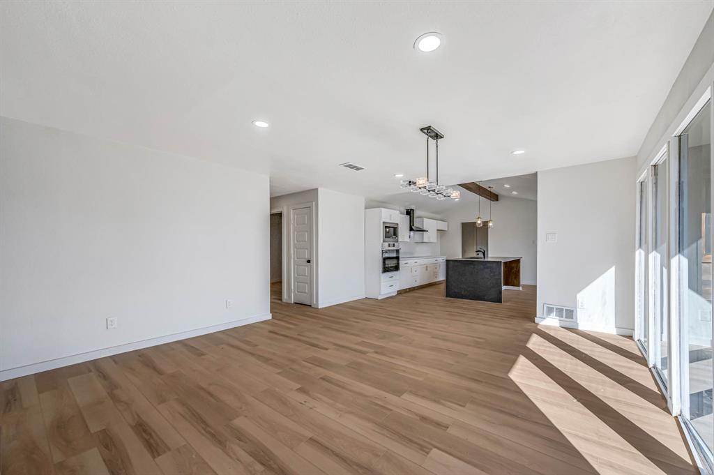 109 Pecan Drive Rowlett, TX 75087 - Photo 18 of 39 a view of empty room with wooden floor and window