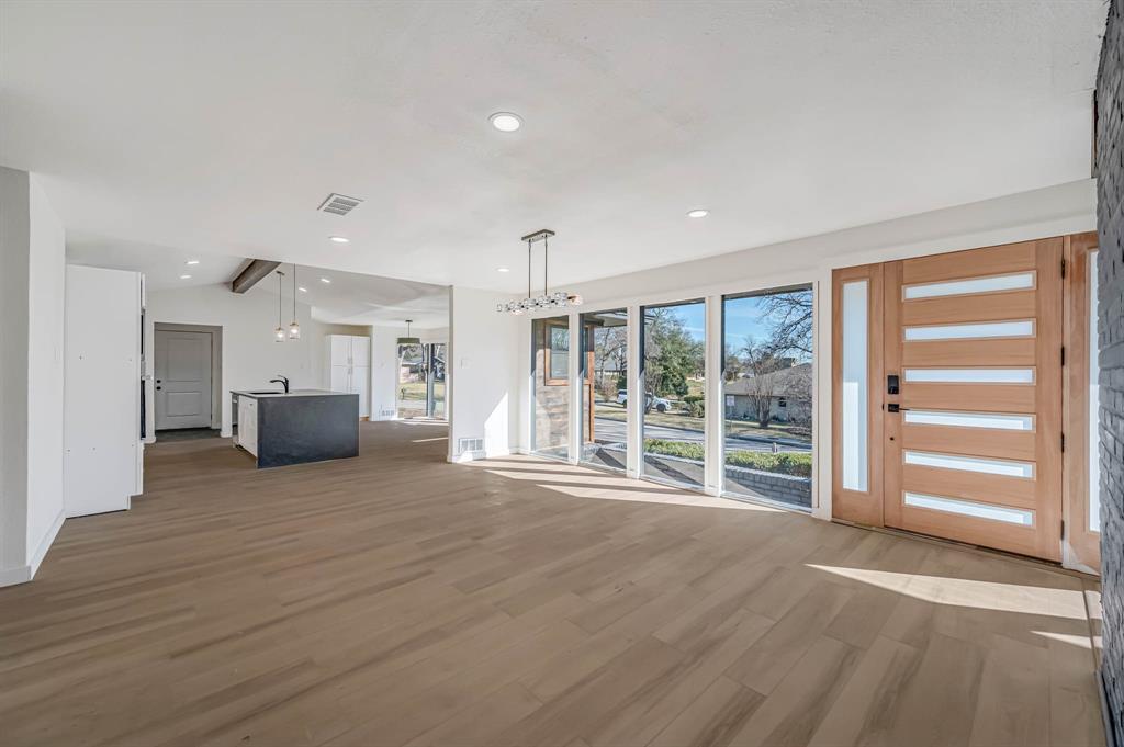 109 Pecan Drive Rowlett, TX 75087 - Photo 19 of 39 a view of empty room with wooden floor and windows