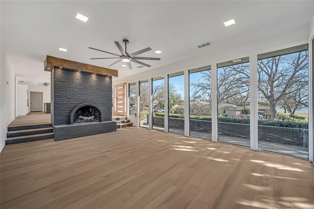 109 Pecan Drive Rowlett, TX 75087 - Photo 20 of 39 a view of an empty room with a fireplace and a large window