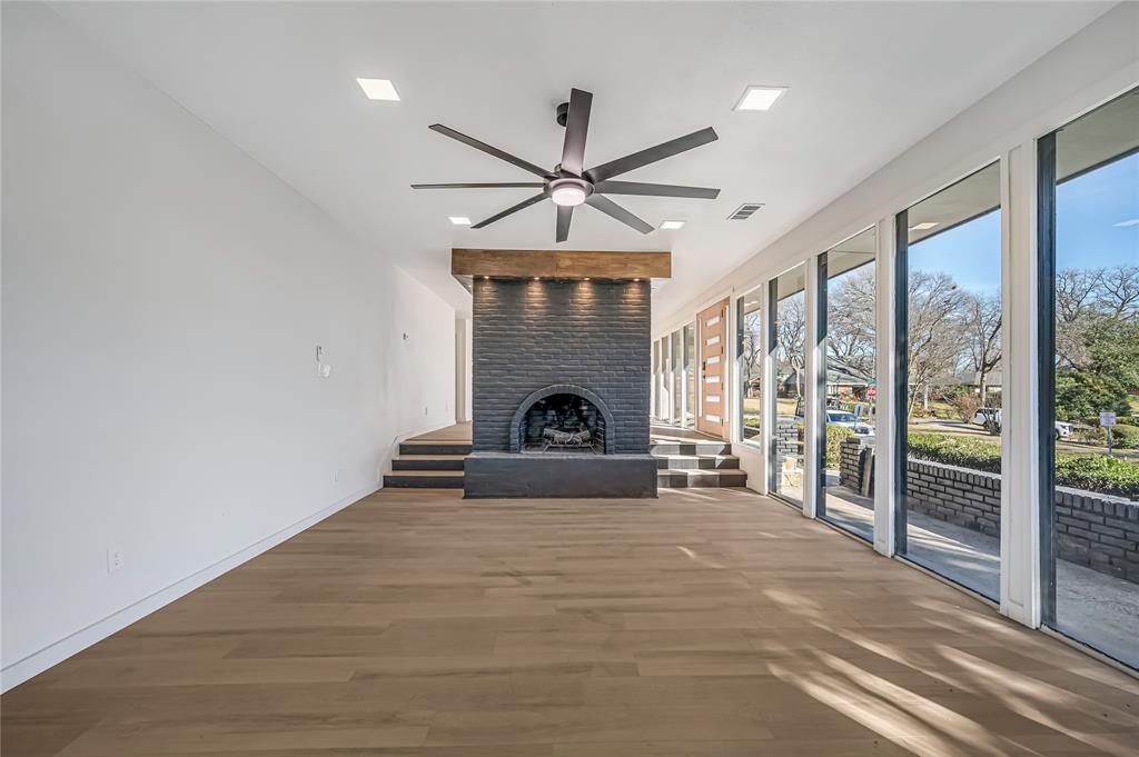 109 Pecan Drive Rowlett, TX 75087 - Photo 22 of 39 a view of a livingroom with a fireplace a ceiling fan and window