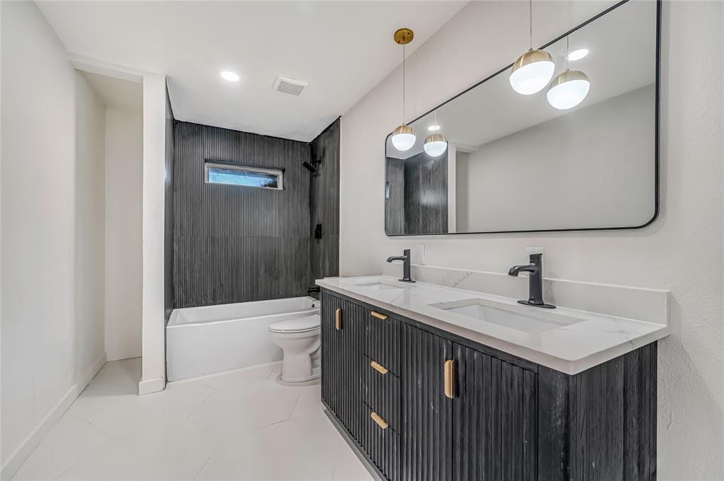 109 Pecan Drive Rowlett, TX 75087 - Photo 25 of 39 a bathroom with a sink a toilet and shower