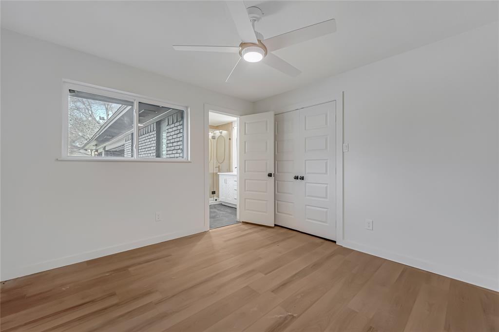 109 Pecan Drive Rowlett, TX 75087 - Photo 27 of 39 an empty room with wooden floor and windows