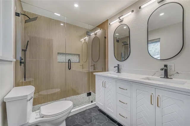 a bathroom with a toilet sink and shower