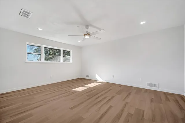wooden floor in an empty room with a window
