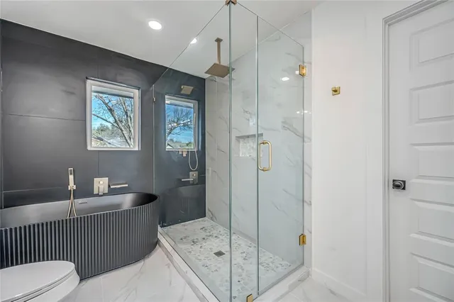 a bathroom with a double vanity sink toilet and shower