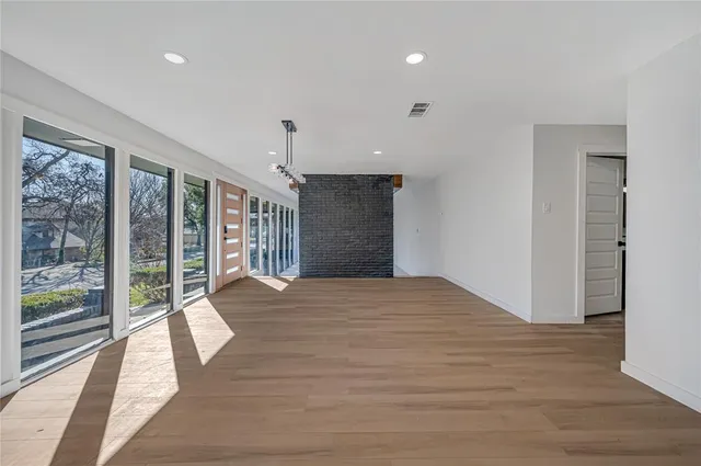 a spacious bedroom with a large bed and a large window